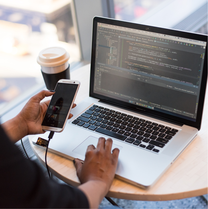 Woman is using computer and mobile phone