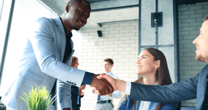 Two men shake hands