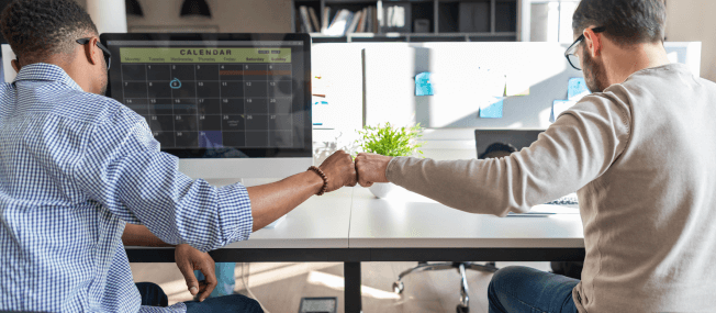 Two men shake hands