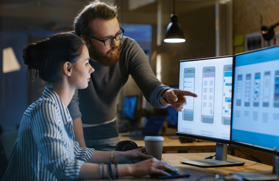 Man is showing woman something on the computer